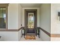 Inviting front entrance with a decorative glass door, elegant sidelights, and a welcoming welcome mat at 1220 Florablu Dr, Seffner, FL 33584