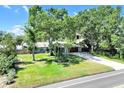 This single-story home is surrounded by beautiful landscaping with a stone-accented facade and plenty of shade trees at 1220 Pinellas Point S Dr, St Petersburg, FL 33705