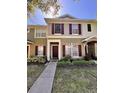 Charming two-story townhome with neutral siding, red shutters, and a welcoming front entrance at 12367 Foxmoor Peak Dr, Riverview, FL 33579