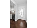 Welcoming foyer with hardwood floors and a decorative glass front door, leading into the home at 14984 Cromwell Dr, Clearwater, FL 33764