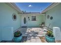 Inviting front porch area with seating and potted plants, creating a warm welcome to the home at 14984 Cromwell Dr, Clearwater, FL 33764