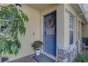 Inviting front door with a decorative wreath, complemented by lush greenery at 222 Draw Bridge Ln, Valrico, FL 33594