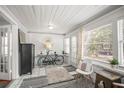 Cozy sunroom featuring bright natural light, stylish decor, and access to the outdoors at 2235 Burlington N Ave, St Petersburg, FL 33713