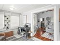 Sunroom with desk and view into living room featuring vaulted ceilings and hardwood flooring at 2235 Burlington N Ave, St Petersburg, FL 33713