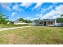 Exterior view of the home with a long driveway and a grassy front yard at 2511 18Th N Ave, St Petersburg, FL 33713