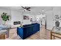 Open-concept living room with fireplace, hardwood floors, neutral walls, and modern furnishings at 2511 18Th N Ave, St Petersburg, FL 33713