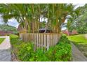 Townhome exterior features a wooden fence surrounding a landscaped yard with a gazebo at 2627 2Nd Ct, Palm Harbor, FL 34684