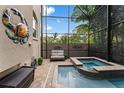 Outdoor patio with a private jacuzzi spa and a crab wall sculpture at 2701 W Bay Ave, Tampa, FL 33611