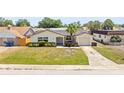 Single-story home featuring an attached garage, well-manicured lawn, and inviting front entrance from the street at 3544 Edenwood Dr, Holiday, FL 34691