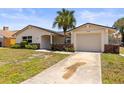 Inviting single-story home with attached garage and a well manicured front yard and clear driveway at 3544 Edenwood Dr, Holiday, FL 34691