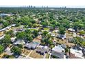 Expansive aerial view of a residential neighborhood with mature trees, showcasing the proximity to city skyline at 4310 S Coolidge Ave, Tampa, FL 33611