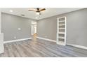 Stylish living room featuring gray walls, laminate floors, and a modern white shelving unit at 4310 S Coolidge Ave, Tampa, FL 33611
