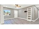 Modern living room showcasing gray walls, stylish laminate floors, and a sleek white shelving unit at 4310 S Coolidge Ave, Tampa, FL 33611