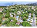 Picturesque aerial shot of homes nestled among green trees in a quiet residential area near the water at 511 San Jose Dr, Dunedin, FL 34698