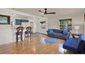 Cozy living area featuring hardwood floors, a ceiling fan, and ample natural light at 511 San Jose Dr, Dunedin, FL 34698