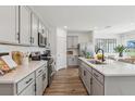 Modern kitchen featuring stainless steel appliances, white countertops, and light gray cabinets at 5133 Harbinger Rd, Spring Hill, FL 34608