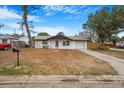 Cozy single-story home with a well-manicured lawn and mailbox, situated in a quiet neighborhood at 5911 63Rd N Ter, Pinellas Park, FL 33781