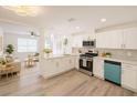 Bright, modern kitchen with stainless steel appliances, sleek countertops, and hardwood floors; a chef's dream at 5911 63Rd N Ter, Pinellas Park, FL 33781