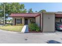 Cozy one-story house with a red-tiled roof, lush lawn, and a convenient parking space at 601 N Hercules Ave # 101, Clearwater, FL 33765