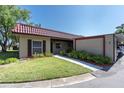 Charming one-story home featuring a red tile roof, green lawn, and well-maintained landscaping at 601 N Hercules Ave # 101, Clearwater, FL 33765
