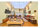 Bright and spacious living room featuring high ceilings, skylights, hardwood floors, and a cozy fireplace at 732 Kingston Ct, Apollo Beach, FL 33572