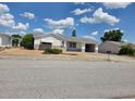 Single-story home featuring an attached garage, awning, and tidy landscaping at 7812 Heather St, New Port Richey, FL 34653