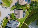 Aerial shot of home showing backyard pool, lush landscaping and waterfront location at 826 Christina Cir, Oldsmar, FL 34677
