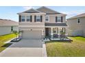 Beautiful two-story home with a two-car garage and a well-maintained front yard at 8607 Bower Bass Cir, Wesley Chapel, FL 33545