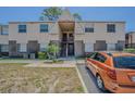 Two-story townhouse with a brick facade and light-colored siding near parking spot at 9031 Westchester Cir # 128, Tampa, FL 33604