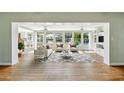 Bright living room with beautiful water view, neutral decor, and hardwood floors at 9265 Treasure Ln Ne, St Petersburg, FL 33702