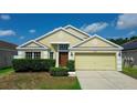 Inviting single-story home with a well-manicured front yard, featuring a two-car garage and lush greenery at 944 Ridge Haven Dr, Brandon, FL 33511