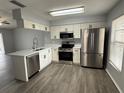 Modern kitchen featuring stainless steel appliances, white cabinets, and stylish countertops at 1010 Lochmont Dr, Brandon, FL 33511