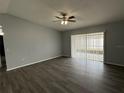 Spacious living room with hardwood floors and sliding glass doors for natural light at 1010 Lochmont Dr, Brandon, FL 33511