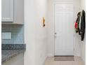 Hallway with a tiled floor, neutral decor, and a white door at 10127 Newel Valley Loop, Riverview, FL 33569