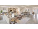 Open-concept living space with modern furnishings flowing into the kitchen and dining area at 10657 Bridgegate Heights Loop, San Antonio, FL 33576