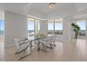Bright dining area with a modern glass table, stylish chairs, and stunning views of the ocean at 1170 Gulf Blvd # 2101, Clearwater Beach, FL 33767