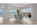 Bright dining area with a modern glass table, stylish chairs, and stunning views of the ocean at 1170 Gulf Blvd # 2101, Clearwater Beach, FL 33767