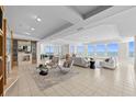 Expansive living room with tile floors, a fireplace, and beautiful ocean views from numerous windows at 1170 Gulf Blvd # 2101, Clearwater Beach, FL 33767