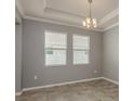 Well-lit living room showcasing tile floors and recessed lighting, complemented by gray paint at 13637 Blythewood Dr, Spring Hill, FL 34609