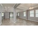 Open-concept living room featuring tile flooring, recessed lighting, and neutral gray wall paint at 13637 Blythewood Dr, Spring Hill, FL 34609