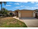 Well-maintained home with lush landscaping, a brick pathway, and a spacious two-car garage at 1601 Westerly Dr, Brandon, FL 33511