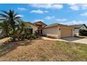 Inviting home featuring a well-kept lawn, a paved walkway, and an attached two-car garage at 1601 Westerly Dr, Brandon, FL 33511