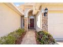 Inviting entryway showcasing a brick walkway and a decorative front door with sidelights at 16802 Fairbolt Way, Odessa, FL 33556