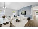 Open-concept living room area with accent wall, hardwood floors and dining area at 1924 Sean Wood Cir, Brandon, FL 33510
