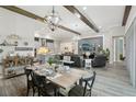 Open-concept living space with dining table and chairs and a comfortable seating area and modern decor at 21746 Amelia Rose Way, Land O Lakes, FL 34637