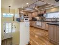 A spacious kitchen with wooden floors, modern appliances, and lots of storage cabinets at 2202 Donato Dr, Belleair Beach, FL 33786