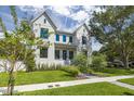 Charming two-story home with modern farmhouse design, lush lawn and mature landscaping at 2218 S Occident St, Tampa, FL 33629