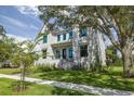 Beautiful two-story modern farmhouse exterior with manicured lawn and mature trees at 2218 S Occident St, Tampa, FL 33629
