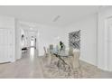 Modern dining room featuring a glass table, stylish chairs, and contemporary decor at 3078 Marine Grass Dr, Wimauma, FL 33598