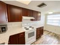 Cozy kitchen featuring wood cabinets, modern appliances, and bright countertops at 3311 Teeside Dr, New Port Richey, FL 34655